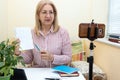 Mature woman teacher conducts online training