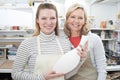 Mature Woman With Teacher Looking At Vase In Pottery Class Royalty Free Stock Photo