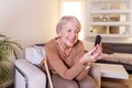 Mature Woman testing for high blood sugar. Woman holding device for measuring blood sugar. Woman doing blood sugar test. Woman Royalty Free Stock Photo