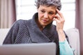 Mature woman thinking while using laptop Royalty Free Stock Photo