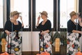 mature woman traveller, looking in the mirror while trying on her sunglasses for a walk along the coast on her summer Royalty Free Stock Photo