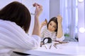 Mature woman treating caring for hair using cosmetic and medical products