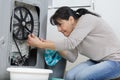 mature woman trying to fix leak at home Royalty Free Stock Photo