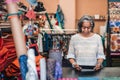 Mature woman using a digital tablet in her fabric store Royalty Free Stock Photo