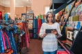 Mature woman using a digital tablet in her textiles shop Royalty Free Stock Photo