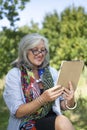 Mature woman using wireless device Royalty Free Stock Photo