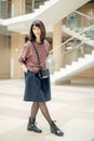 Mature woman walking confidently in mall while looking at camera Royalty Free Stock Photo