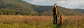 Mature woman walking her beautiful hungarian vizsla. Dog walking background. Woman and hunting dog enjoying nature walk.