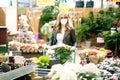 Mature woman wearing face mask for prevention while shopping in garden center Royalty Free Stock Photo