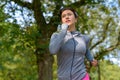 Mature woman wearing grey jacket and jogging