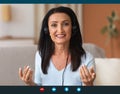 Mature Woman Wearing Headset Having Video Conference Royalty Free Stock Photo