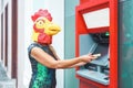 Mature woman wearing mask withdraw money from bank cash machine with debit card - Surreal image of half human and animal Royalty Free Stock Photo