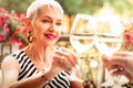 Mature woman wearing massive earrings drinking wine with husband Royalty Free Stock Photo