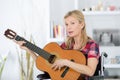 Mature woman in wheelchair playing guitar Royalty Free Stock Photo