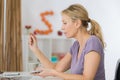 Mature woman working with documents at table in home