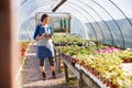 Mature Woman Working In Garden Center Greenhouse Holding Digital Tablet And Checking Plants Royalty Free Stock Photo