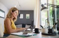 Mature woman working indoors in home office in container house in backyard. Royalty Free Stock Photo