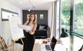 Mature woman working indoors in home office in container house in backyard. Royalty Free Stock Photo