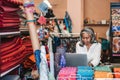 Mature woman working on a laptop in her textiles shop Royalty Free Stock Photo