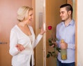 Mature woman and young guy at doorway Royalty Free Stock Photo