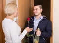 Mature woman and young guy at doorway Royalty Free Stock Photo