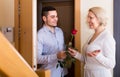 Mature woman and young guy at doorway Royalty Free Stock Photo