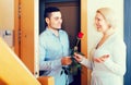 Mature woman and young guy at doorway Royalty Free Stock Photo