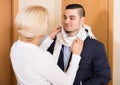 Mature woman and young guy at doorway Royalty Free Stock Photo