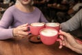 Mature women drinking coffee in cafe, closeup