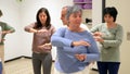 Mature women in a Qi gong class choreographing the exercises