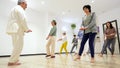 Mature women in a Qi gong class choreographing the exercises