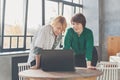 Mature women working laptop computer indoors Royalty Free Stock Photo