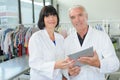 Mature worker and colleague - laundry service team Royalty Free Stock Photo