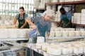 Mature worker pours slip mass from jug into plaster mold in pottery factory Royalty Free Stock Photo