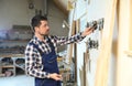 Mature working man in uniform choosing blade for circular saw