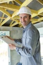 mature workman holding blank clipboard