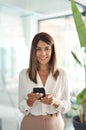 Mature business woman worker using cell phone in office, vertical portrait. Royalty Free Stock Photo