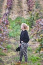 Mature young blondy farmer woman in a farmland with vineyards.