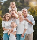 Mature and young family members outside in the garden. Happy smiling parents relaxing outside with their children Royalty Free Stock Photo