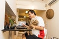 Matured Asian business man work from home accompanied by pet dog during lockdown