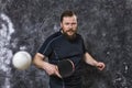 Matured bearded man plays table tennis studio portrait.