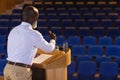 Matured businessman practicing for speech in the empty auditorium Royalty Free Stock Photo