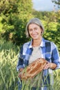 Matured farm woman with freshly baked bread