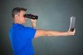 Man With Hyperopia Eye Disorder Reading A Book Using Binocular