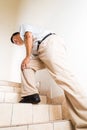 Matured man suffering acute knee joint pain climbing stairs Royalty Free Stock Photo