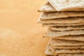 Matzah Passover celebration concept. Traditional ritual Jewish bread on sand color old wall background. Passover food. Pesach