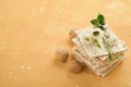 Matzah Passover celebration concept. Traditional ritual Jewish bread on sand color old wall background. Passover food. Pesach