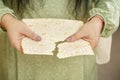 A matzah plate in the hands of a Jewish woman.