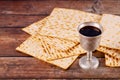 Matzah and a silver cup full of wine. Jewish holidays concept