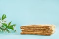 Matzo bread and spring flowers on a blue background. Religious Jewish holiday Passover or Pesach. Copy space. Royalty Free Stock Photo